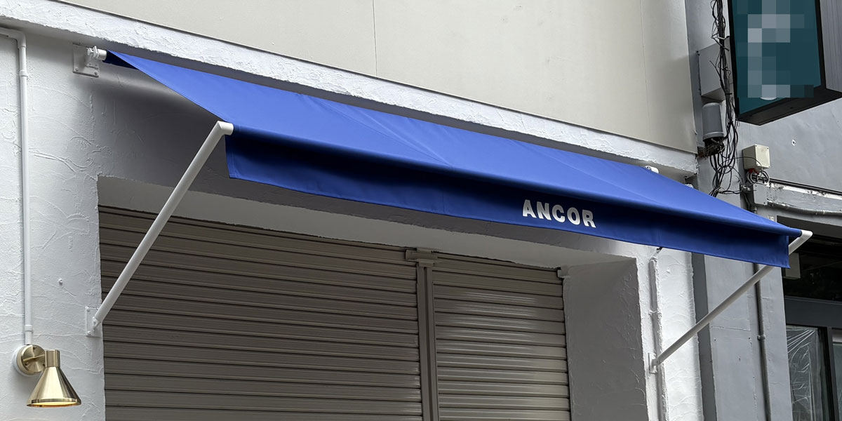 腕の伸縮を省いたシンプルモダンなオリジナル巻き上げ式テントの設置